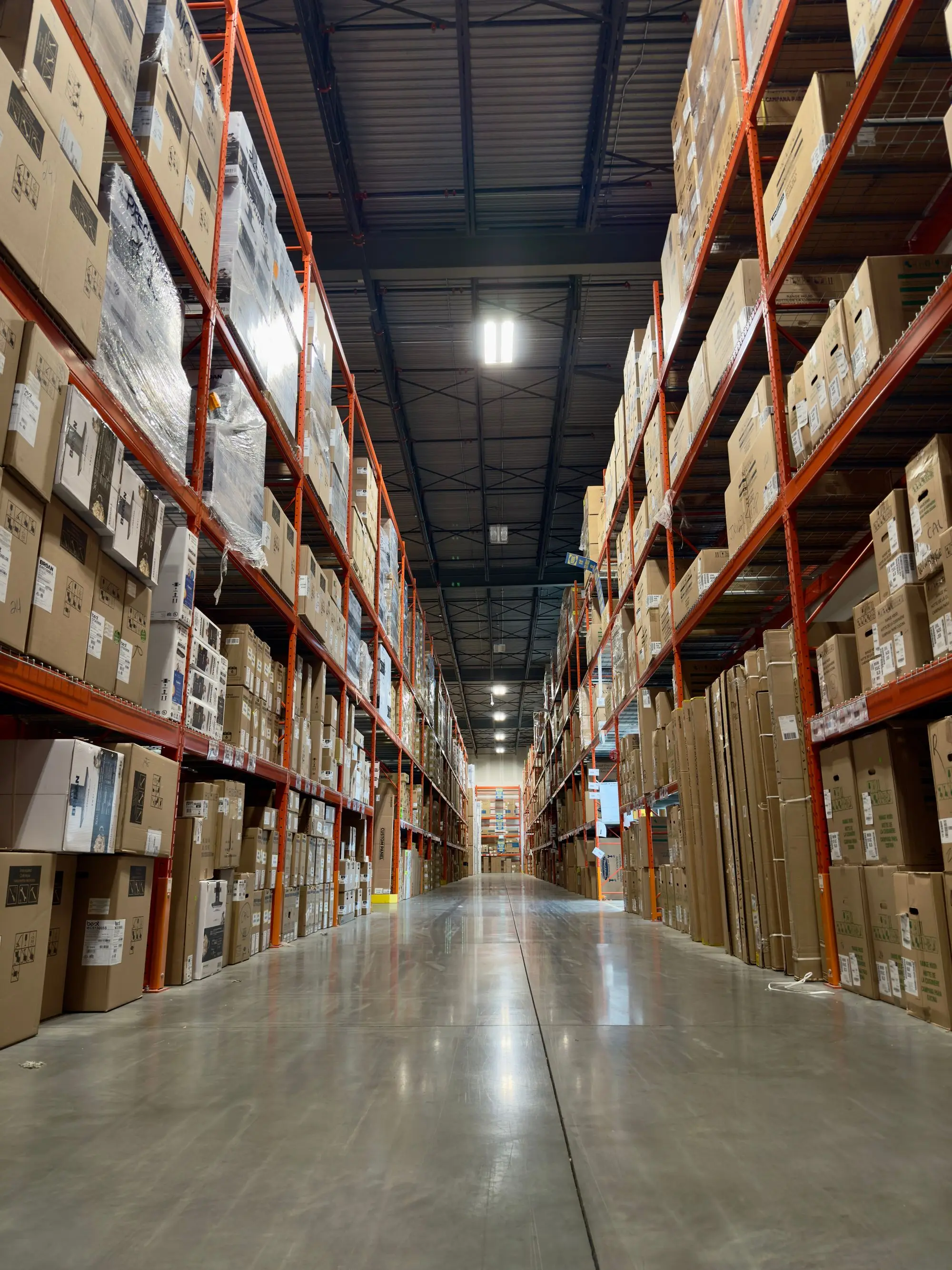 Pallet racking running the length of a distribution centre aisle.