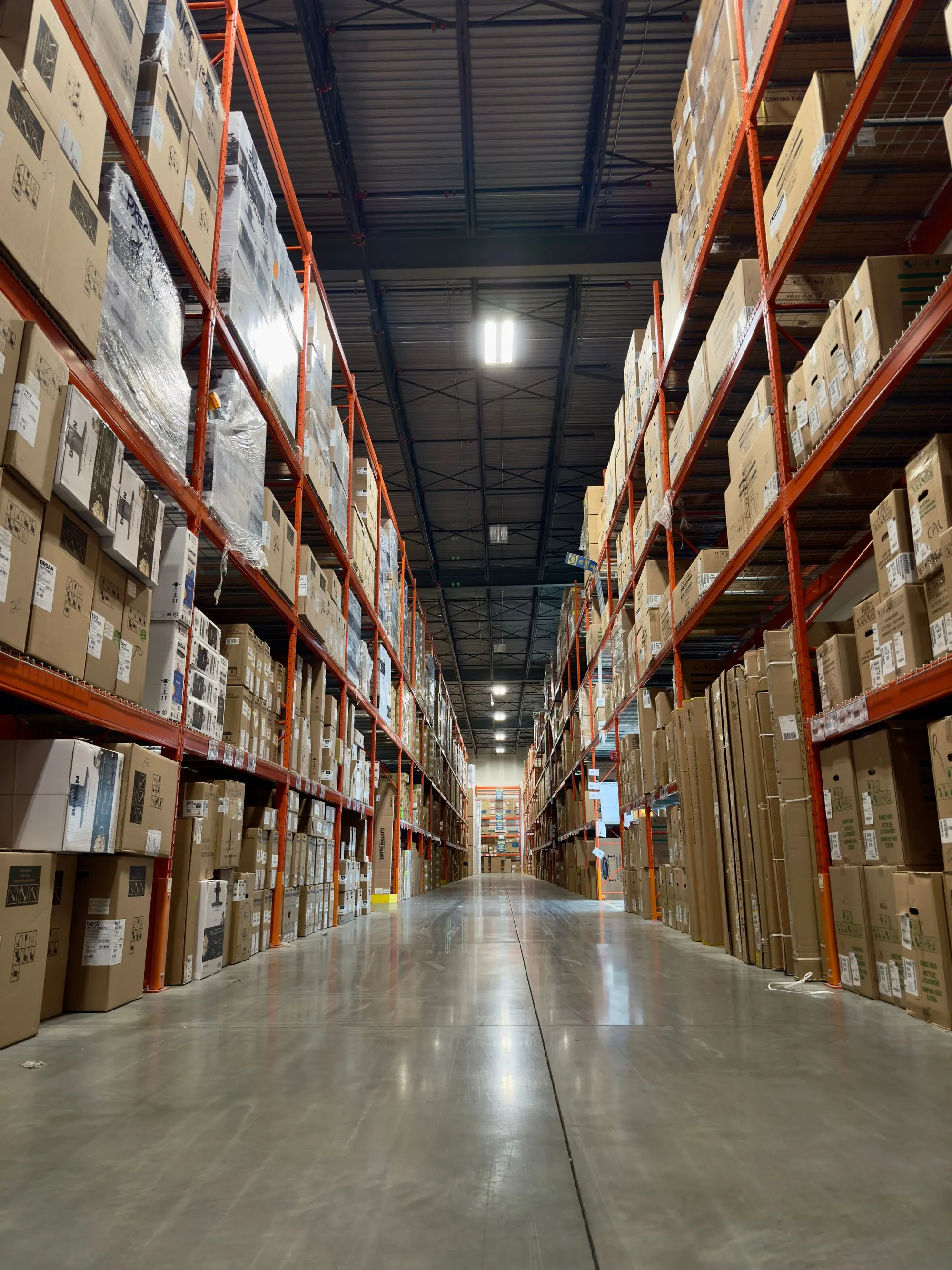 Pallet racking running the length of a distribution centre aisle.