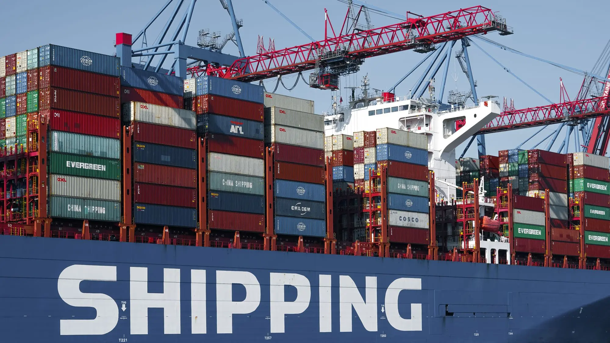Container ship alongside gantry cranes at the Port of Hamburg.